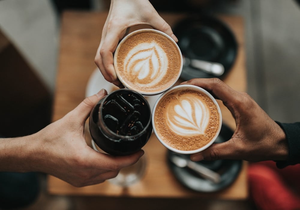 Round table at a neighbourhood coffee shop with an empty cup.